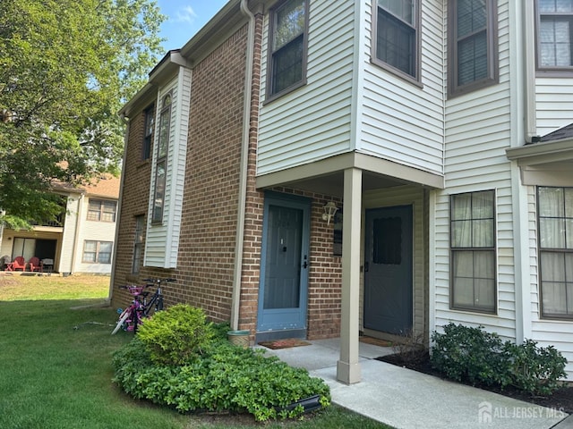 1202 Harbor Club Dr, Sayreville, NJ 08859 - entrance to property with brick siding and a yard