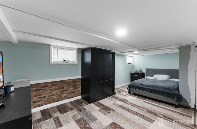 40 Highland St, East Brunswick, NJ 08816 - bedroom featuring wood finished floors, brick wall, and multiple windows
