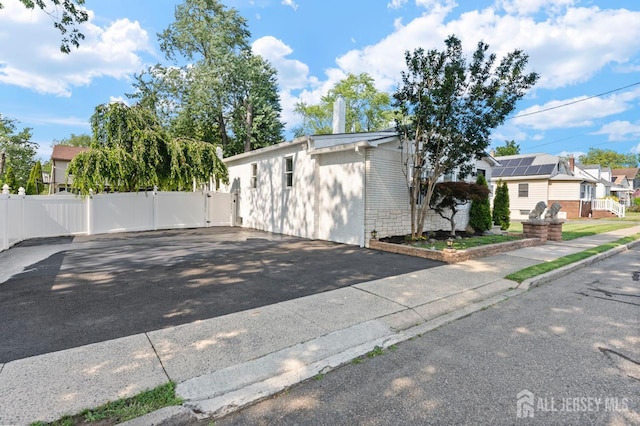 40 Highland St, East Brunswick, NJ 08816 - view of front of home with a gate, asphalt driveway, and a residential view