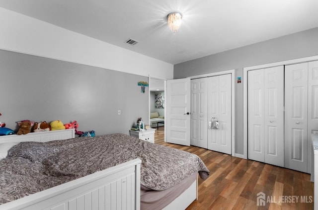 40 Highland St, East Brunswick, NJ 08816 - bedroom featuring multiple closets and wood finished floors