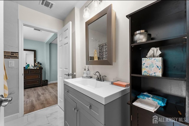 40 Highland St, East Brunswick, NJ 08816 - bathroom featuring vanity and marble look tile flooring