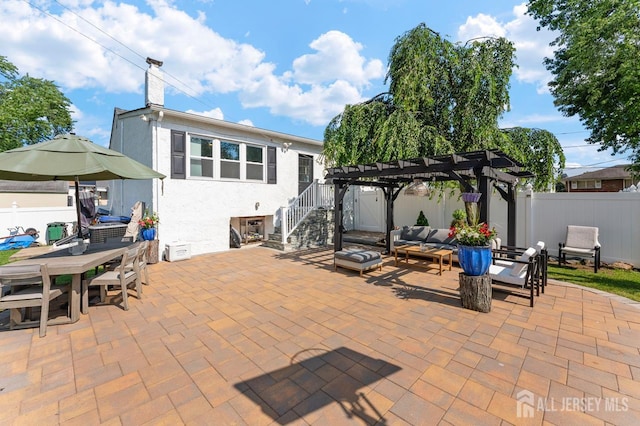 40 Highland St, East Brunswick, NJ 08816 - fenced backyard featuring a pergola, an outdoor hangout area, a patio area, outdoor dining area, and stairs