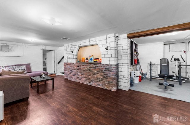 40 Highland St, East Brunswick, NJ 08816 - living room with wood finished floors, stairway, and brick wall
