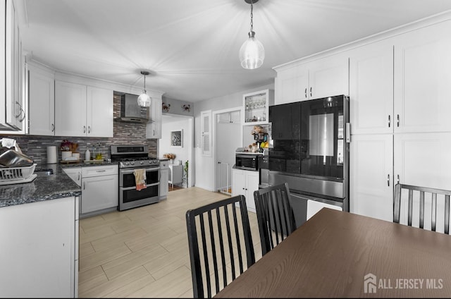 40 Highland St, East Brunswick, NJ 08816 - kitchen featuring stainless steel appliances, wall chimney range hood, backsplash, radiator, and white cabinetry