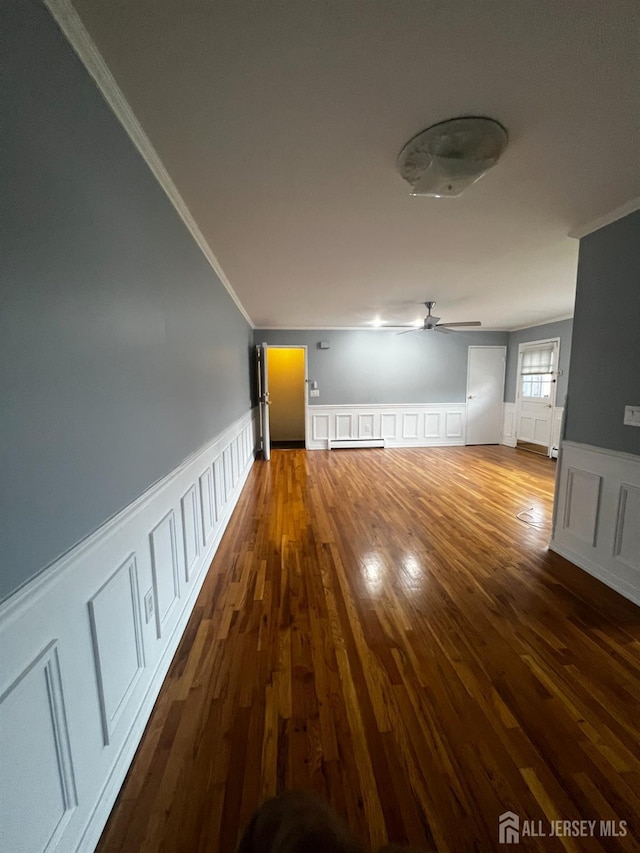 55 Gills Ln Unit 64, Iselin, NJ 08830 - spare room with crown molding, a decorative wall, a wainscoted wall, a ceiling fan, and wood finished floors