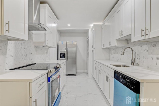 kitchen featuring white cabinets, wall chimney exhaust hood, appliances with stainless steel finishes, marble finish floor, and a sink