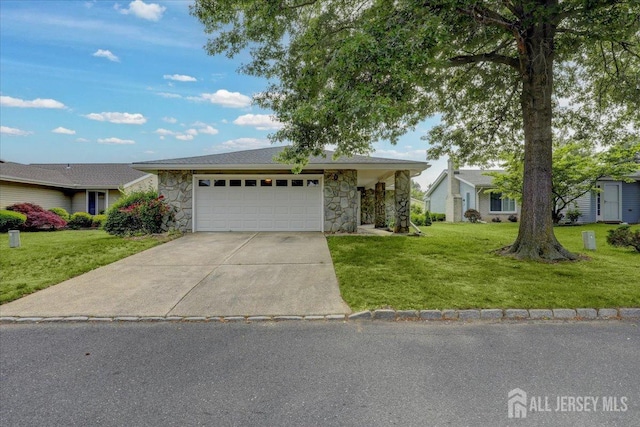 ranch-style house with an attached garage, stone siding, concrete driveway, and a front yard