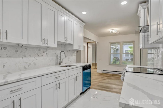 kitchen with dishwasher, backsplash, white cabinetry, a baseboard heating unit, and a sink