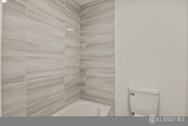 bathroom featuring toilet and shower / bathing tub combination