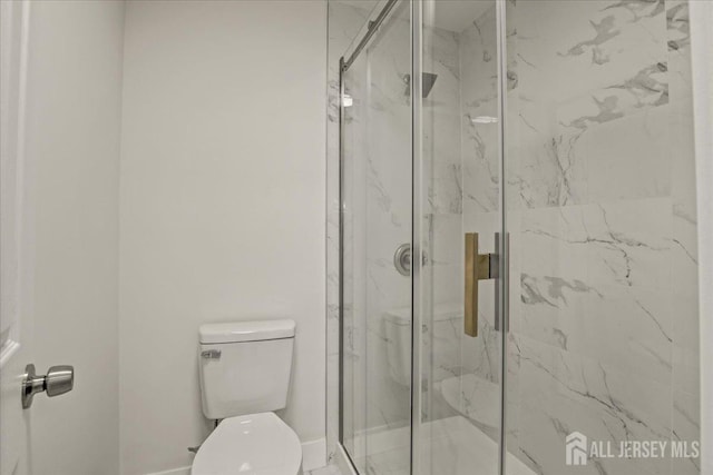 full bathroom featuring a marble finish shower and toilet