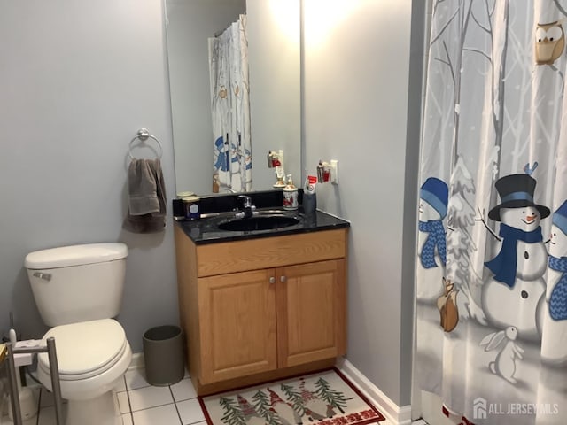 full bath featuring toilet, tile patterned flooring, vanity, and baseboards