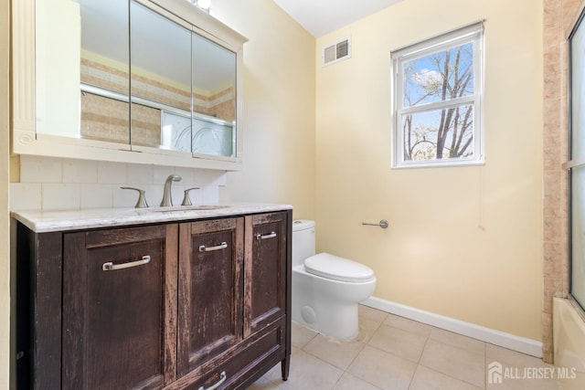 full bathroom with visible vents, vanity, toilet, baseboards, and tile patterned floors