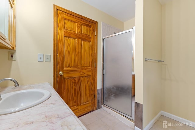 full bathroom with vanity, tile patterned floors, and a shower stall