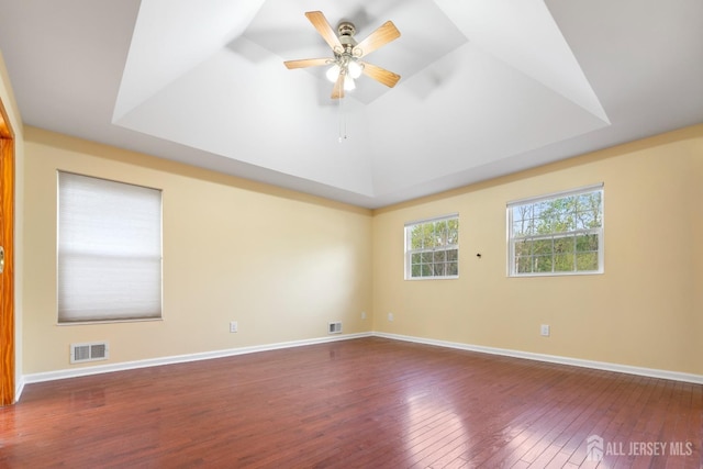 unfurnished room featuring visible vents, a ceiling fan, and hardwood / wood-style flooring