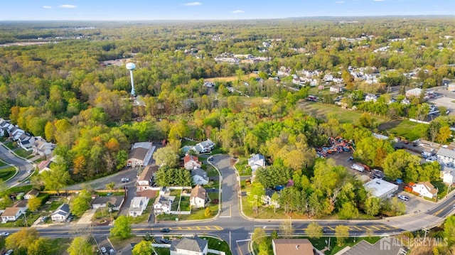 birds eye view of property featuring a residential view and a wooded view