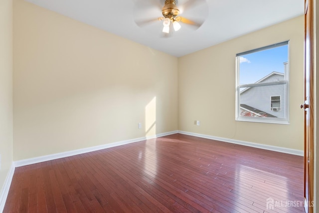 empty room featuring baseboards, ceiling fan, and hardwood / wood-style floors