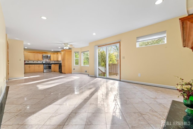 unfurnished living room featuring baseboards, recessed lighting, and marble finish floor