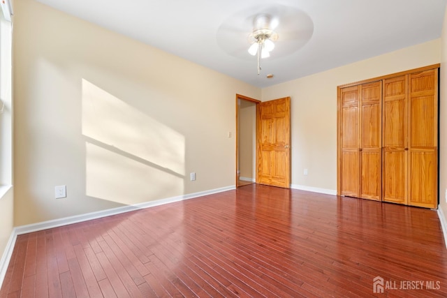unfurnished bedroom with baseboards, ceiling fan, and hardwood / wood-style floors