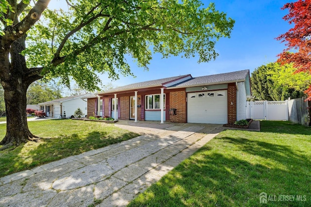 32 Drake Ave, Monroe, NJ 08831 - ranch-style home with an attached garage, brick siding, driveway, and a porch