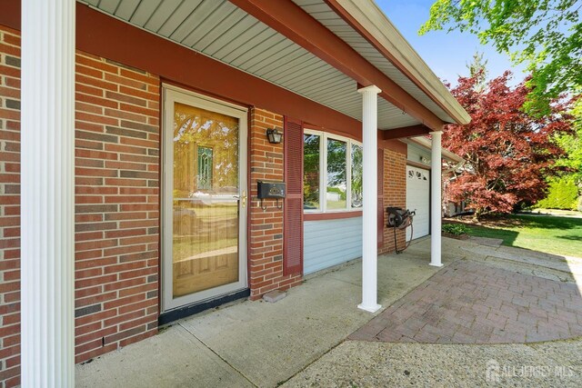 32 Drake Ave, Monroe, NJ 08831 - doorway to property with brick siding and a porch