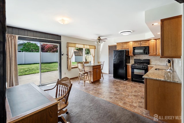 32 Drake Ave, Monroe, NJ 08831 - kitchen with black appliances, a sink, decorative backsplash, a ceiling fan, and light stone countertops