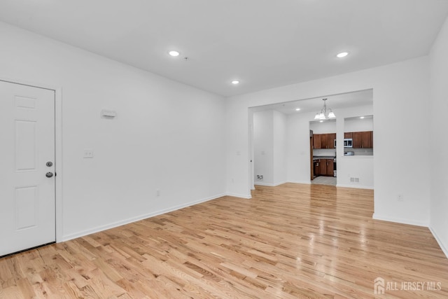 116 Forest Dr, Piscataway, NJ 08854 - unfurnished living room with light wood finished floors, recessed lighting, and a chandelier