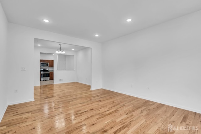116 Forest Dr, Piscataway, NJ 08854 - unfurnished living room with a chandelier, light wood finished floors, and recessed lighting
