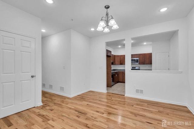 116 Forest Dr, Piscataway, NJ 08854 - unfurnished living room featuring a chandelier, light wood finished floors, and recessed lighting