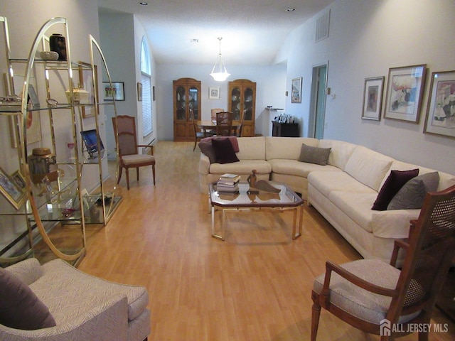 living area with light wood-type flooring and visible vents