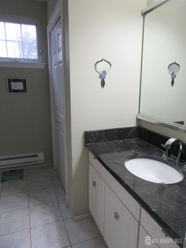 bathroom featuring a closet, baseboard heating, tile patterned flooring, and vanity