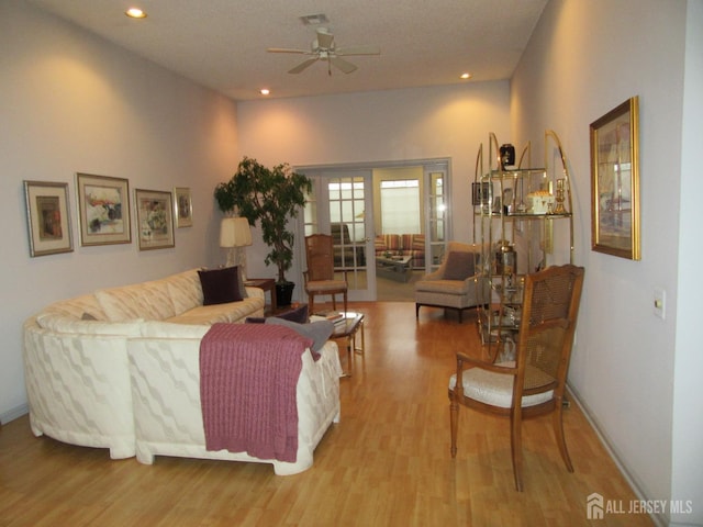 living area featuring baseboards, recessed lighting, ceiling fan, and wood finished floors