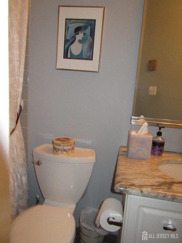 bathroom with toilet and vanity