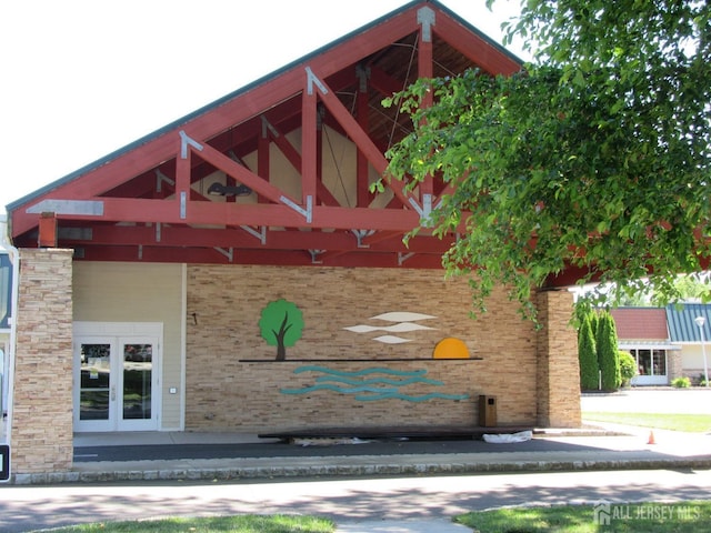 exterior space featuring french doors and brick siding