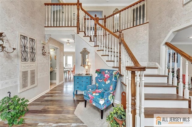 18 Jason Ct, Colonia, NJ 07067 - stairway featuring wallpapered walls, wood finished floors, a towering ceiling, and crown molding