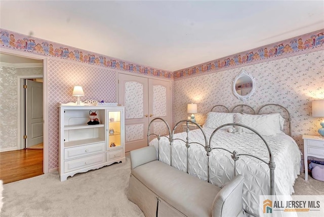 bedroom with wallpapered walls, light colored carpet, baseboards, and ornamental molding