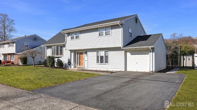 view of front of home featuring a garage and a front lawn