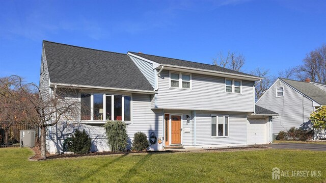 tri-level home with a front yard