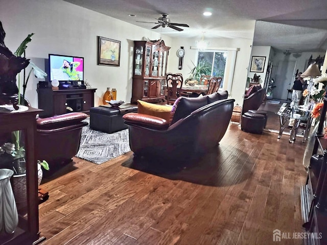 living room with hardwood / wood-style flooring and a ceiling fan