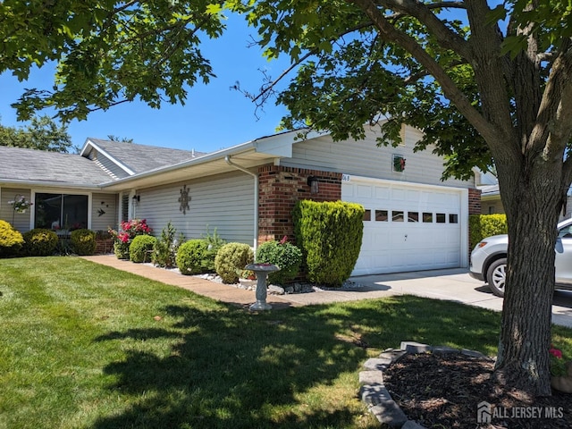 view of home's exterior with an attached garage, a yard, concrete driveway, and brick siding