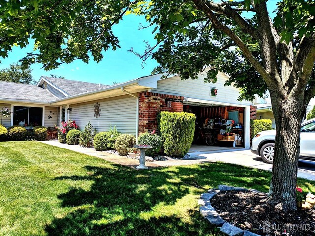 view of property exterior featuring a lawn and a garage