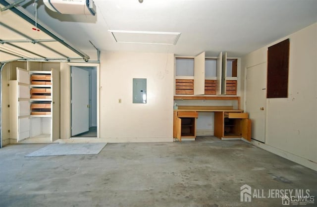 garage featuring electric panel and a garage door opener