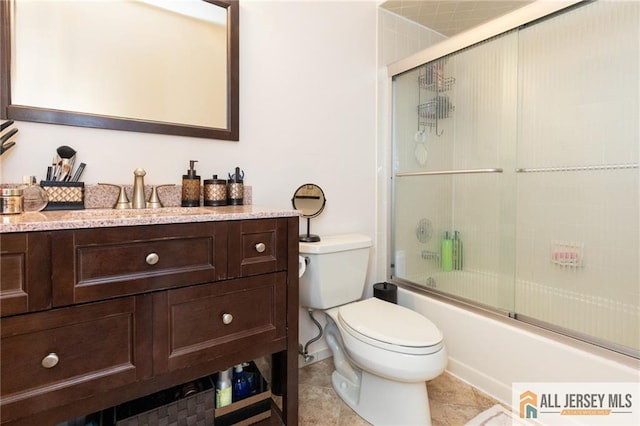 full bathroom with shower / bath combination with glass door, tile patterned floors, toilet, and vanity