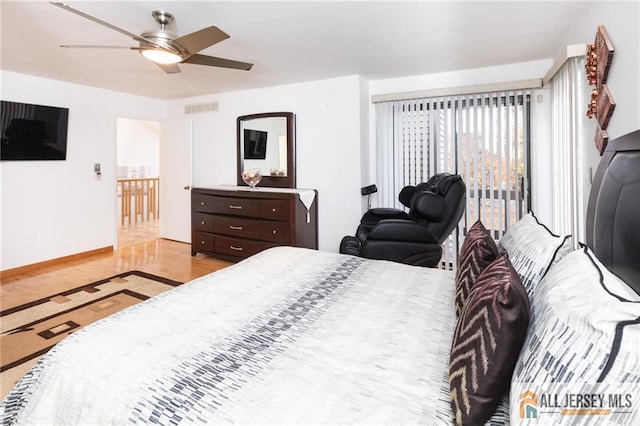 bedroom featuring a ceiling fan, baseboards, visible vents, and light wood-style flooring