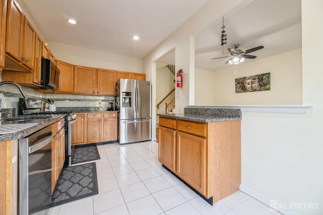 1404 Yarrow Cir S, Brunswick, NJ 08810 - kitchen with appliances with stainless steel finishes, ceiling fan, decorative backsplash, light tile patterned floors, and brown cabinets