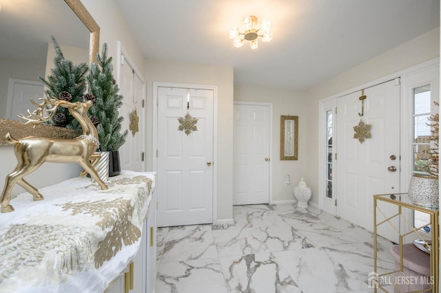 29 Chimney Ct, Old Bridge, NJ 08879 - entryway featuring light marble finish flooring, baseboards, and a chandelier