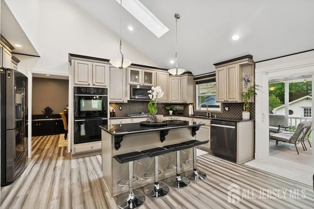 9 Valley Forge Dr, East Brunswick, NJ 08816 - kitchen featuring stainless steel appliances, dark countertops, light wood-style floors, healthy amount of natural light, and lofted ceiling