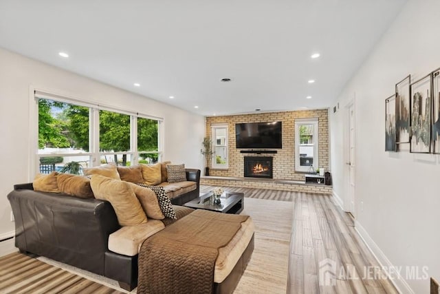 9 Valley Forge Dr, East Brunswick, NJ 08816 - living room featuring wood finished floors, healthy amount of natural light, a fireplace, and recessed lighting