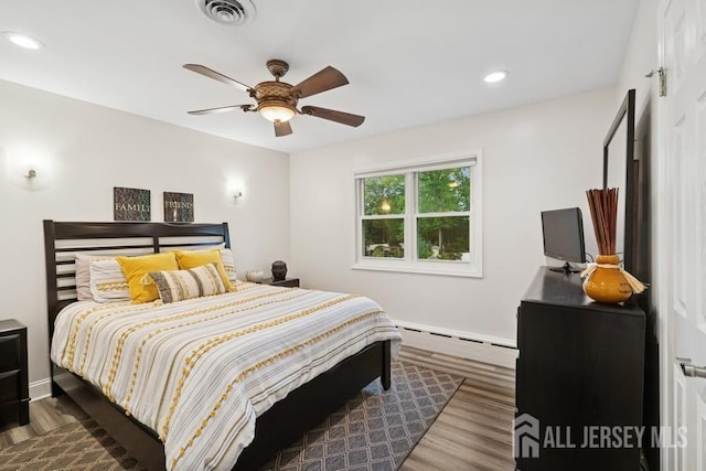 9 Valley Forge Dr, East Brunswick, NJ 08816 - bedroom featuring a baseboard heating unit, wood finished floors, ceiling fan, and recessed lighting