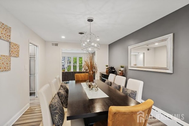 9 Valley Forge Dr, East Brunswick, NJ 08816 - dining space featuring wood finished floors, a chandelier, a baseboard radiator, and recessed lighting