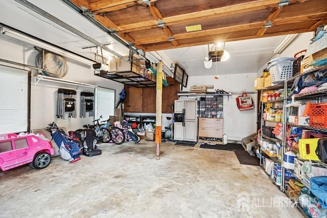 9 Valley Forge Dr, East Brunswick, NJ 08816 - garage with a garage door opener and paneled fridge with ice dispenser